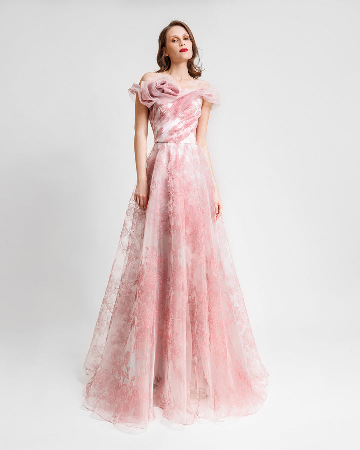 An off-the-shoulders pink evening dress with a floral draped neckline and a flowy skirt.