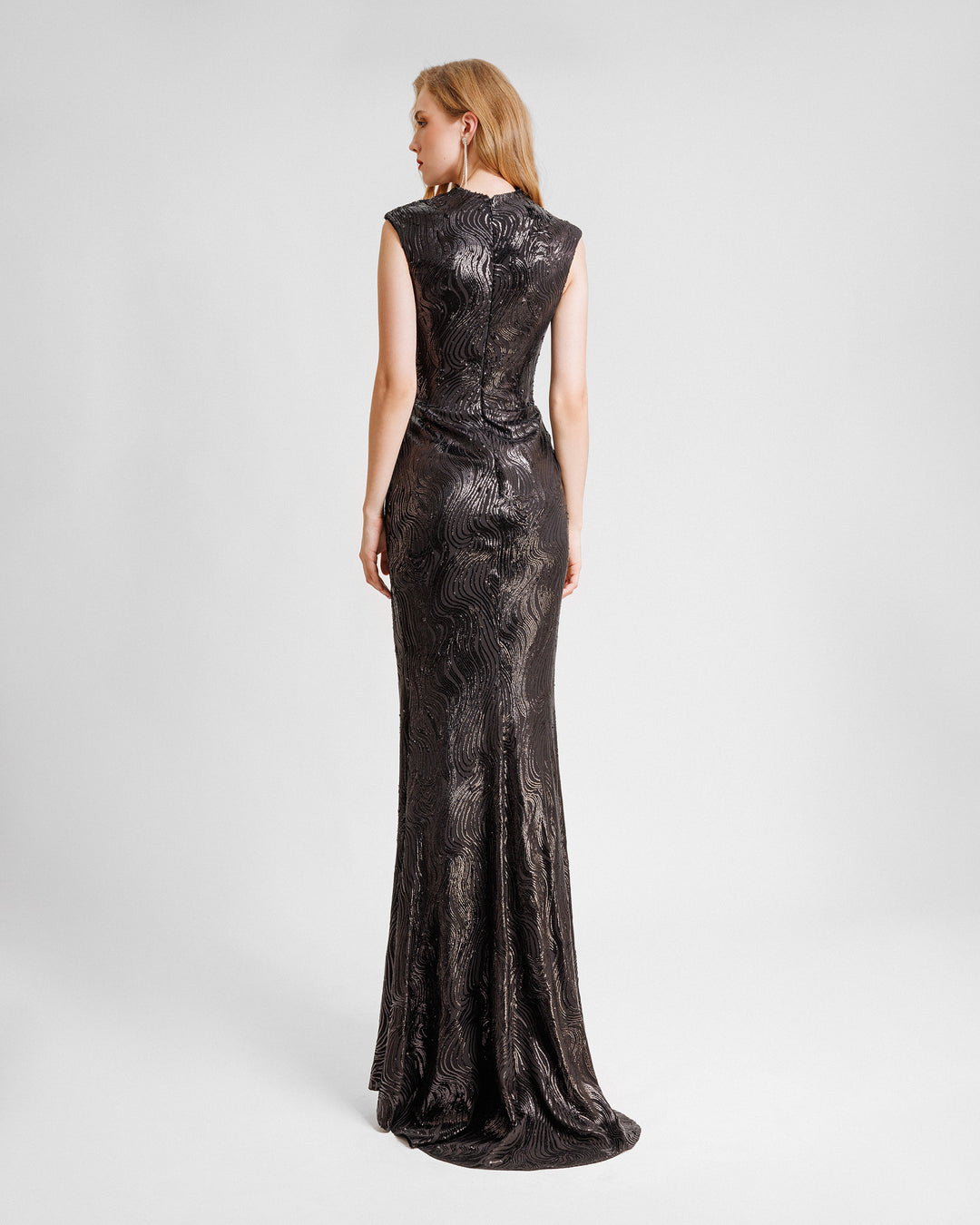 The back off a slim-cut fully sequined black evening dress.