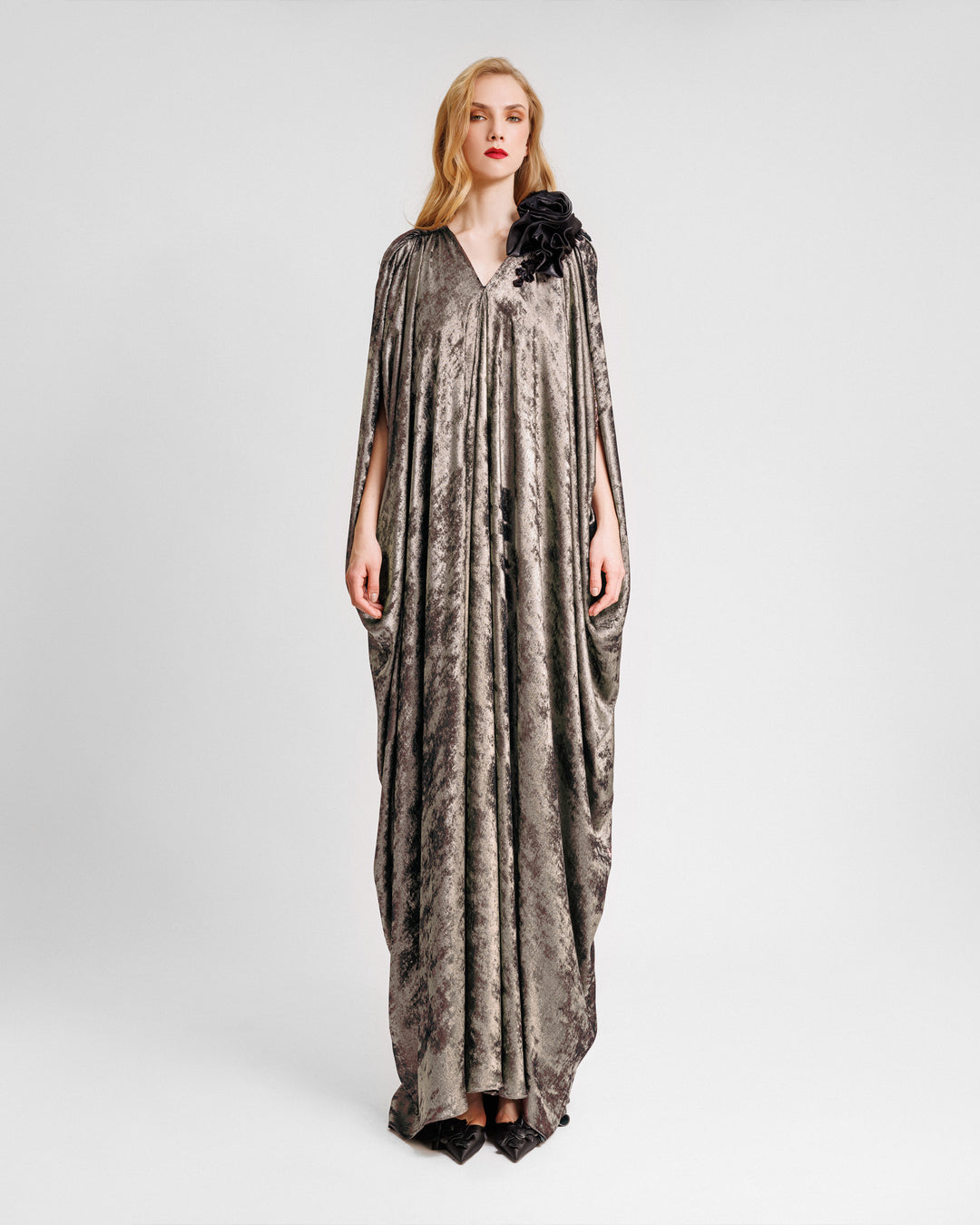 A v-neckline loose-cut kaftan dress with floral draping on the shoulder.