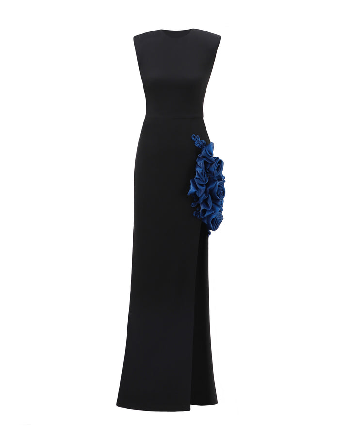 A slim-cut black evening dress featuring petrol floral draping and a slit on the side.