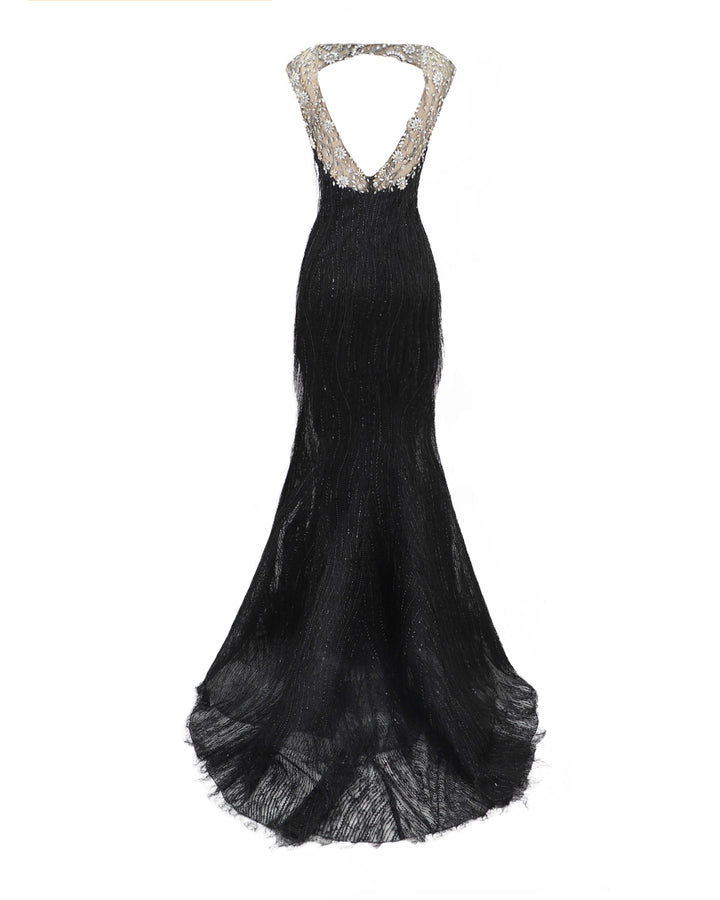 The back of a black fringes evening dress with a beaded neck and shoulders, and an open back.