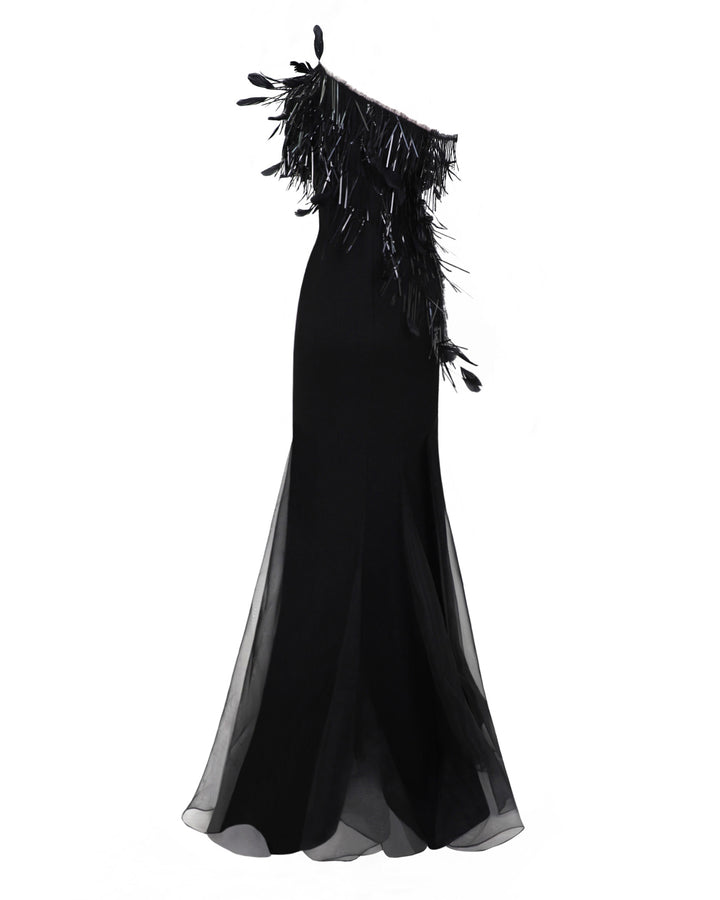 The back of an asymmetrical feather neckline black evening dress with flared organza stripes.