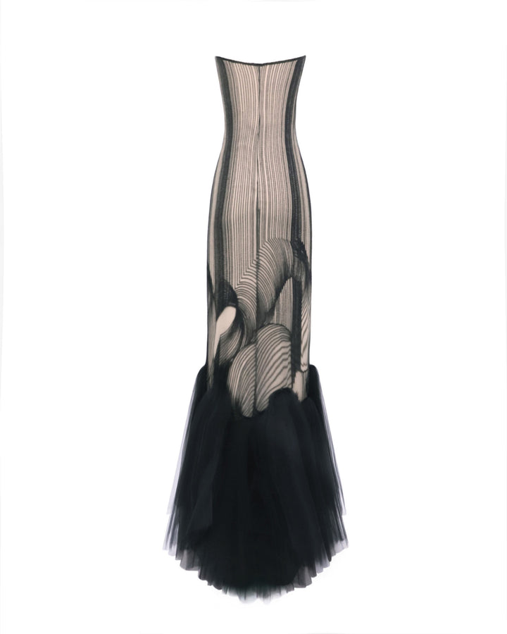 The back of an embroidered pattern black slim-cut dress with a gathered tulle hemline.