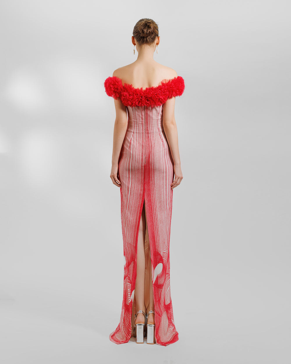 An off-the-shoulders slim-cut red evening dress with rushed organza on the neckline and an open slit at the back.