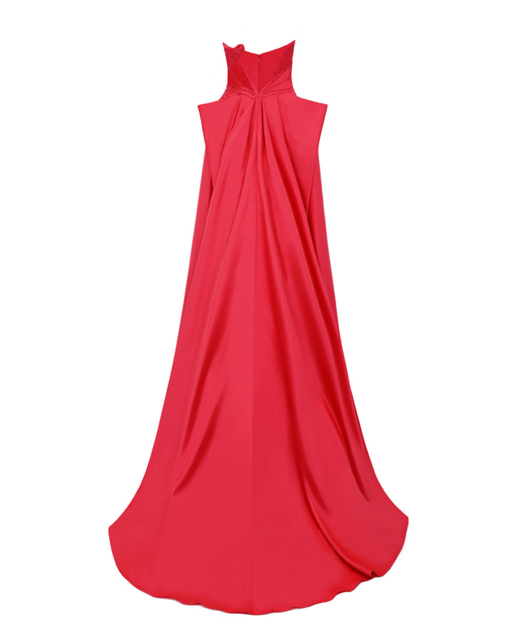 The back of a strapless red evening dress with laser-cut details, a wide flared cut, and draping at the back.