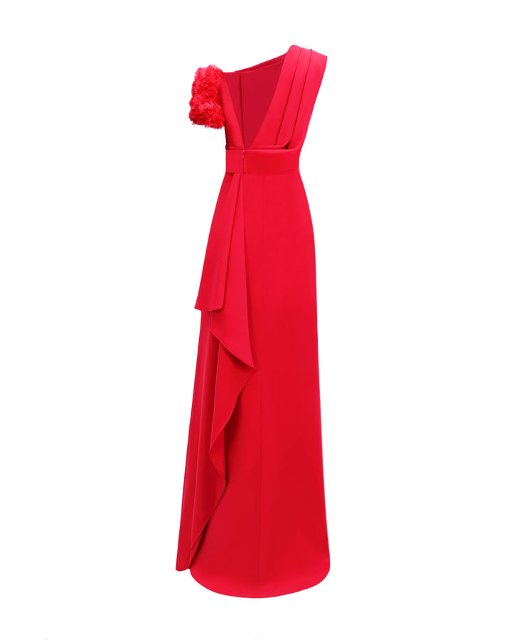 The back of a one-shoulder red evening dress with a rushed organza short sleeve, draped open back, and a ruffled slit.