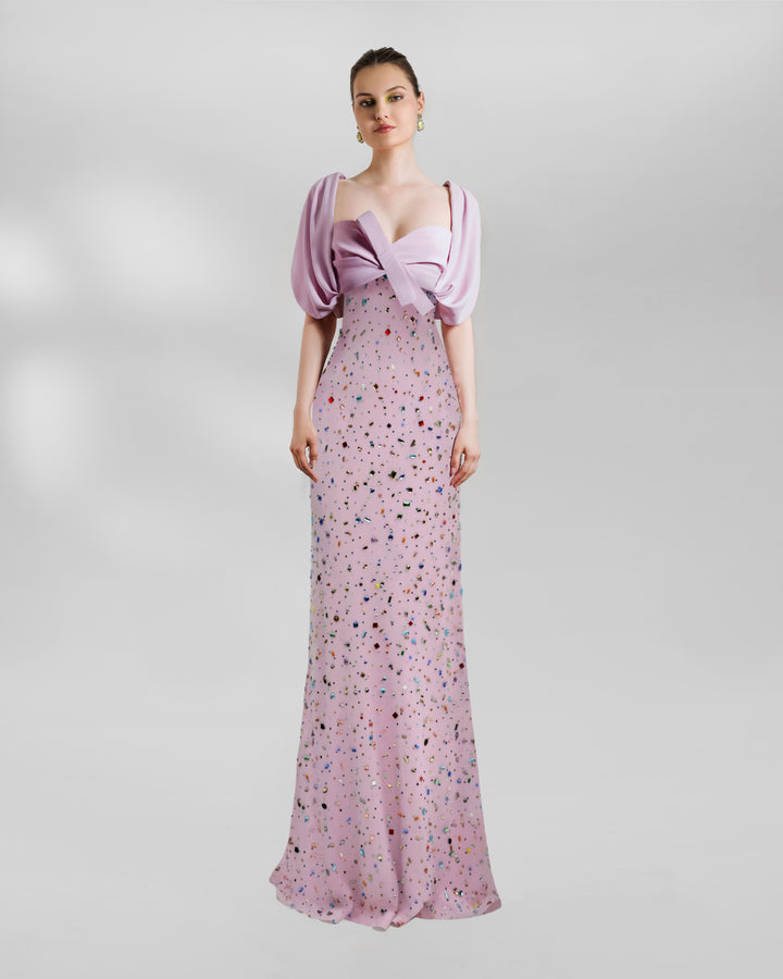 A puffed-shoulders, draped cropped top paired with a beaded Long skirt forming an amazing long multicolor beaded pink dress.