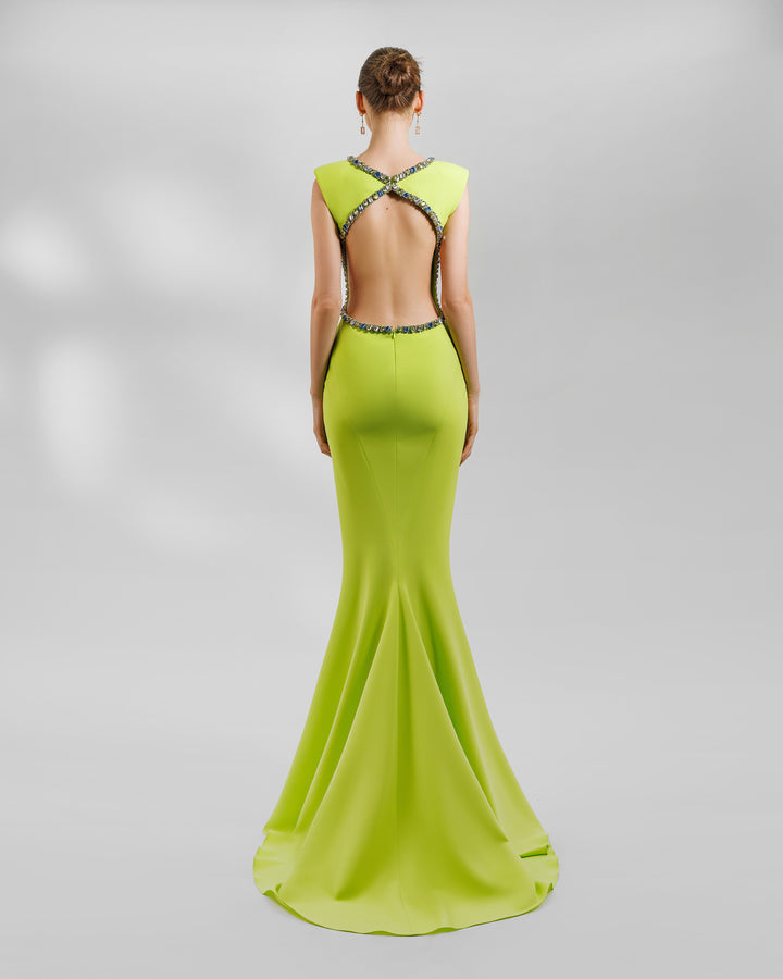 The back of a slim-cut padded shoulders lime long evening dress, featuring beadings on the neckline and the open back.