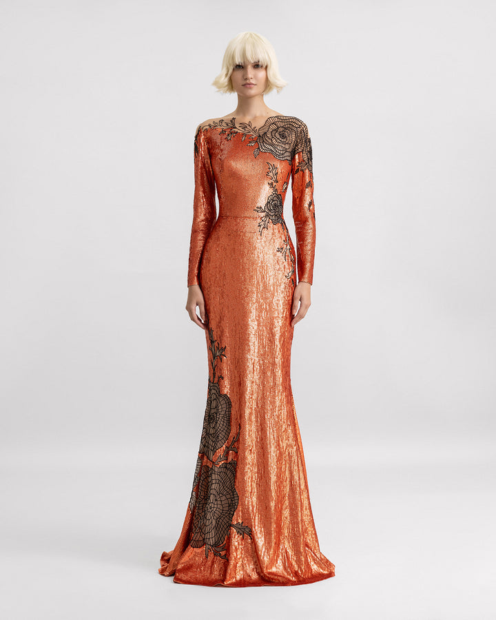 A long-sleeve embroidered sequins dress in copper color with a small tail and black floral beadings.