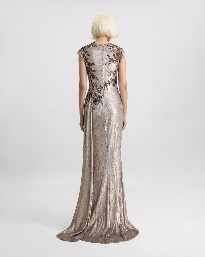 The back of an embroidered sequins slim-cut evening dress in greige color with a black beaded floral design.