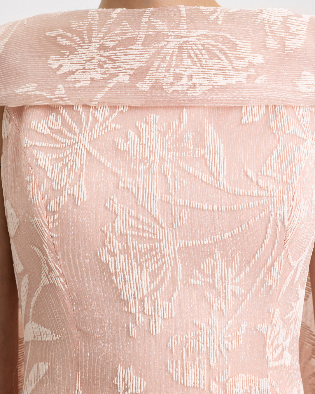 A close-up of an evening dress in light pink pleated organza Jacquard.