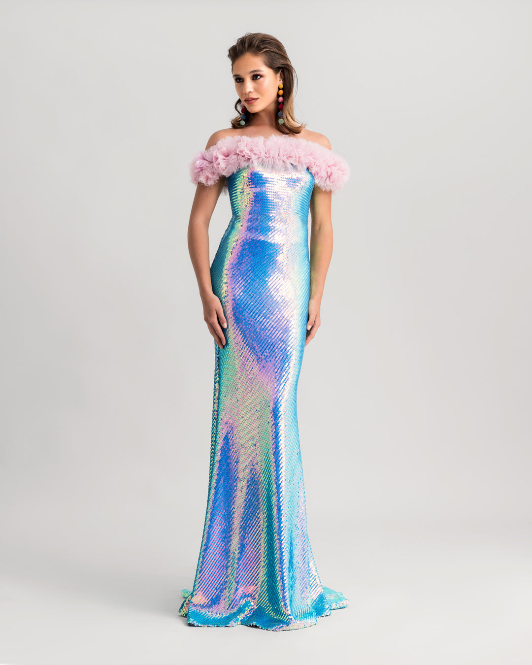 A sequined slim-cut evening dress in aqua blue with a pink rushed tulle on the neckline.