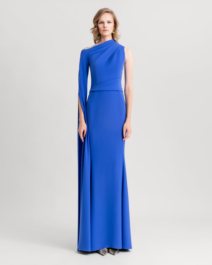 An asymmetrical neckline blue evening dress with draping on the shoulder and waist, and a floor-length sleeve.