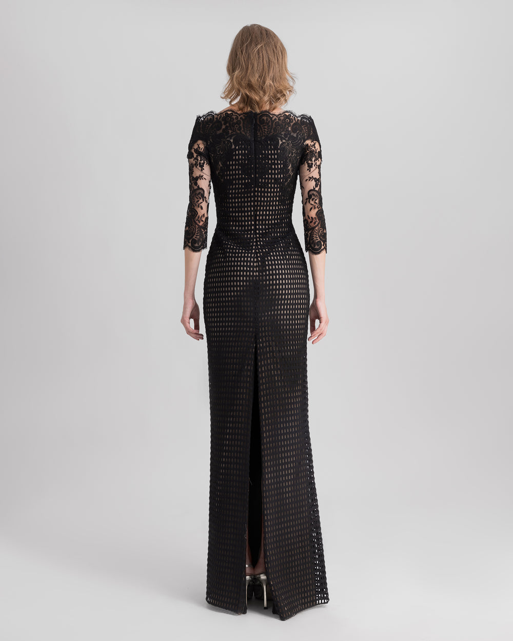 The back of an off-the-shoulders, black crochet lace evening dress.