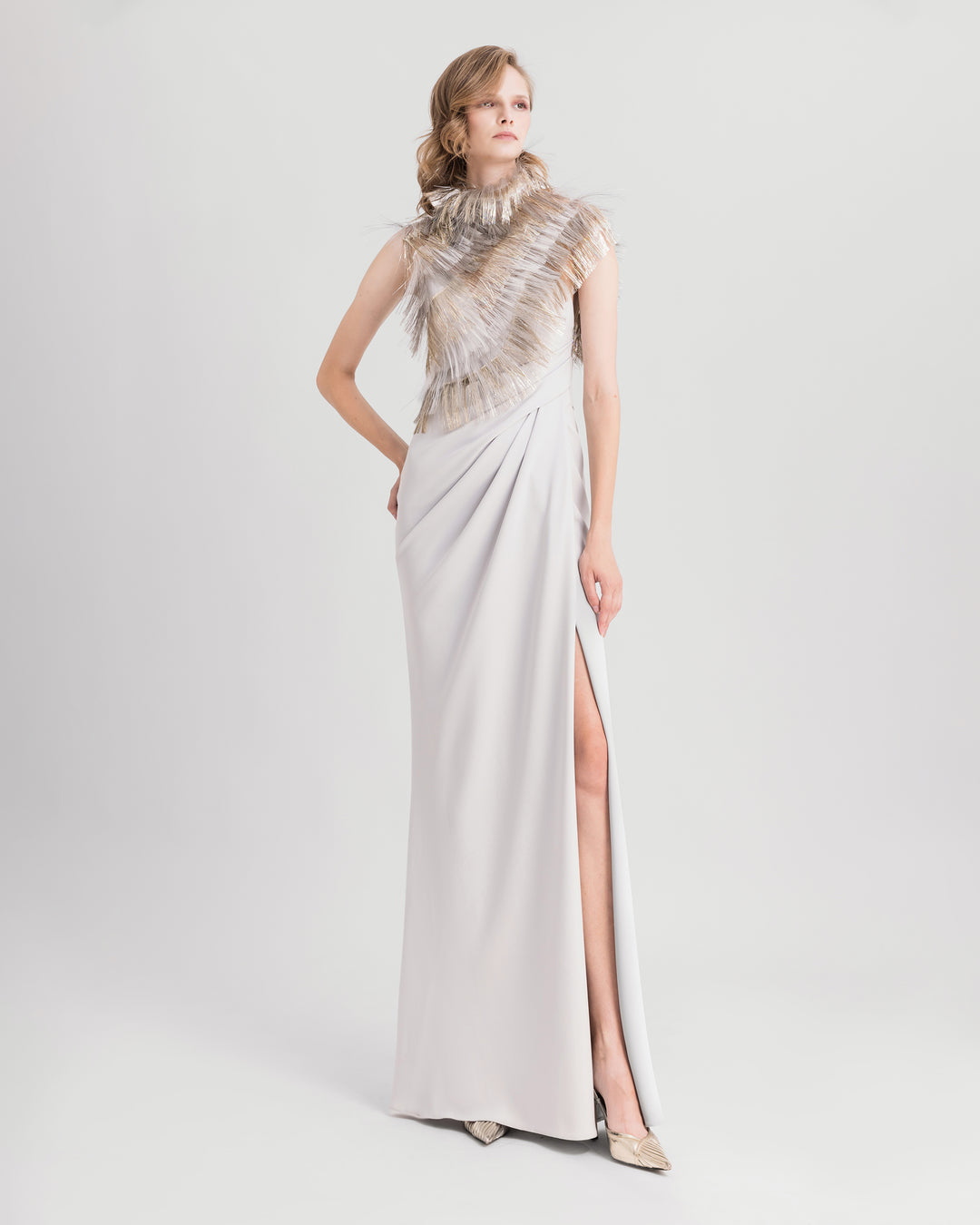 An asymmetrical neckline dress featuring draping on the waist and an open slit on the side.