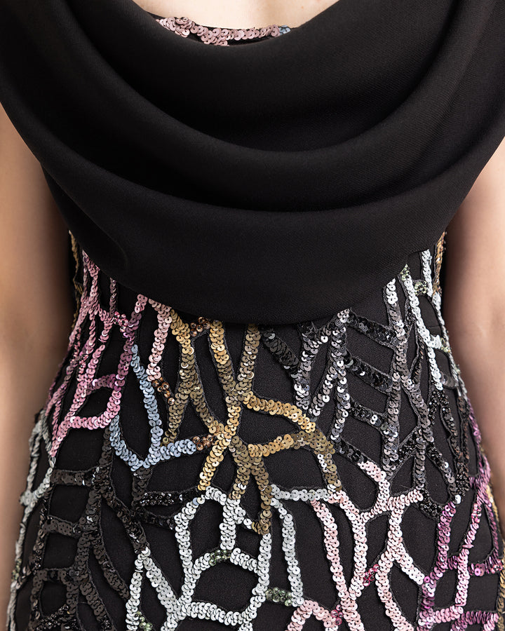 a close-up of a slim-cut beaded evening dress with draped crepe neckline.