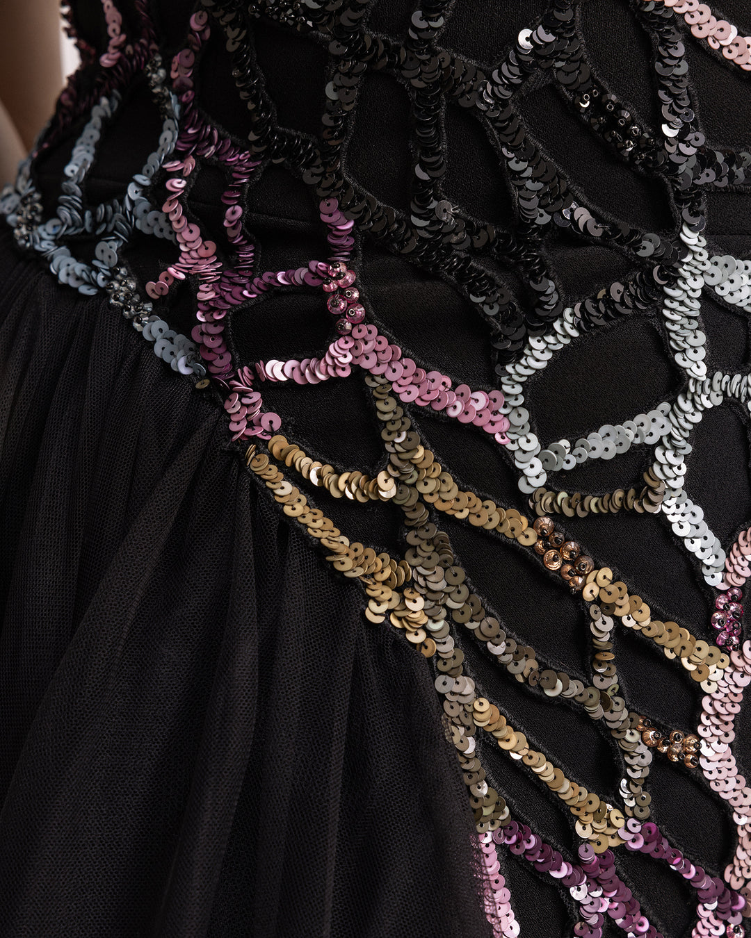 A close-up of a beaded black evening dress.