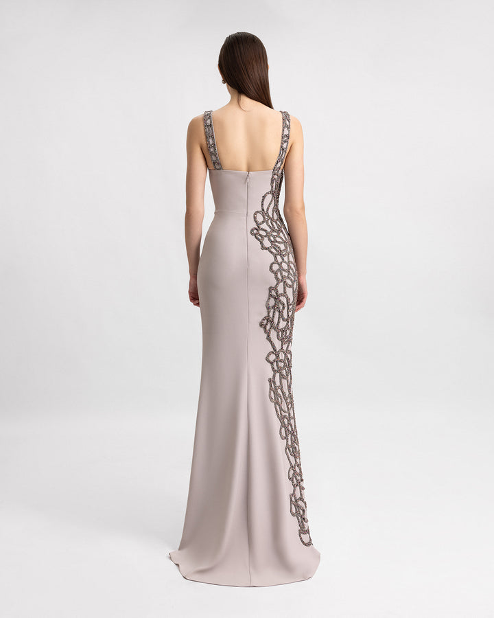 The back a slim-cut evening dress with asymmetrical beading details.