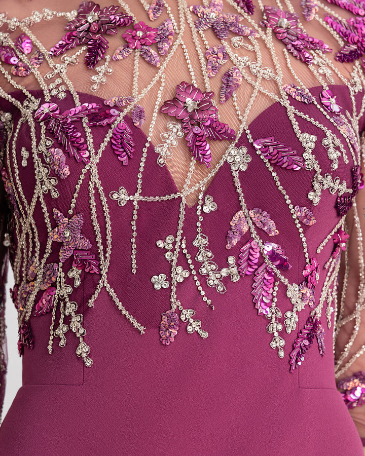 A close-up of a slim-cut evening dress in mulberry color with a beaded corset.