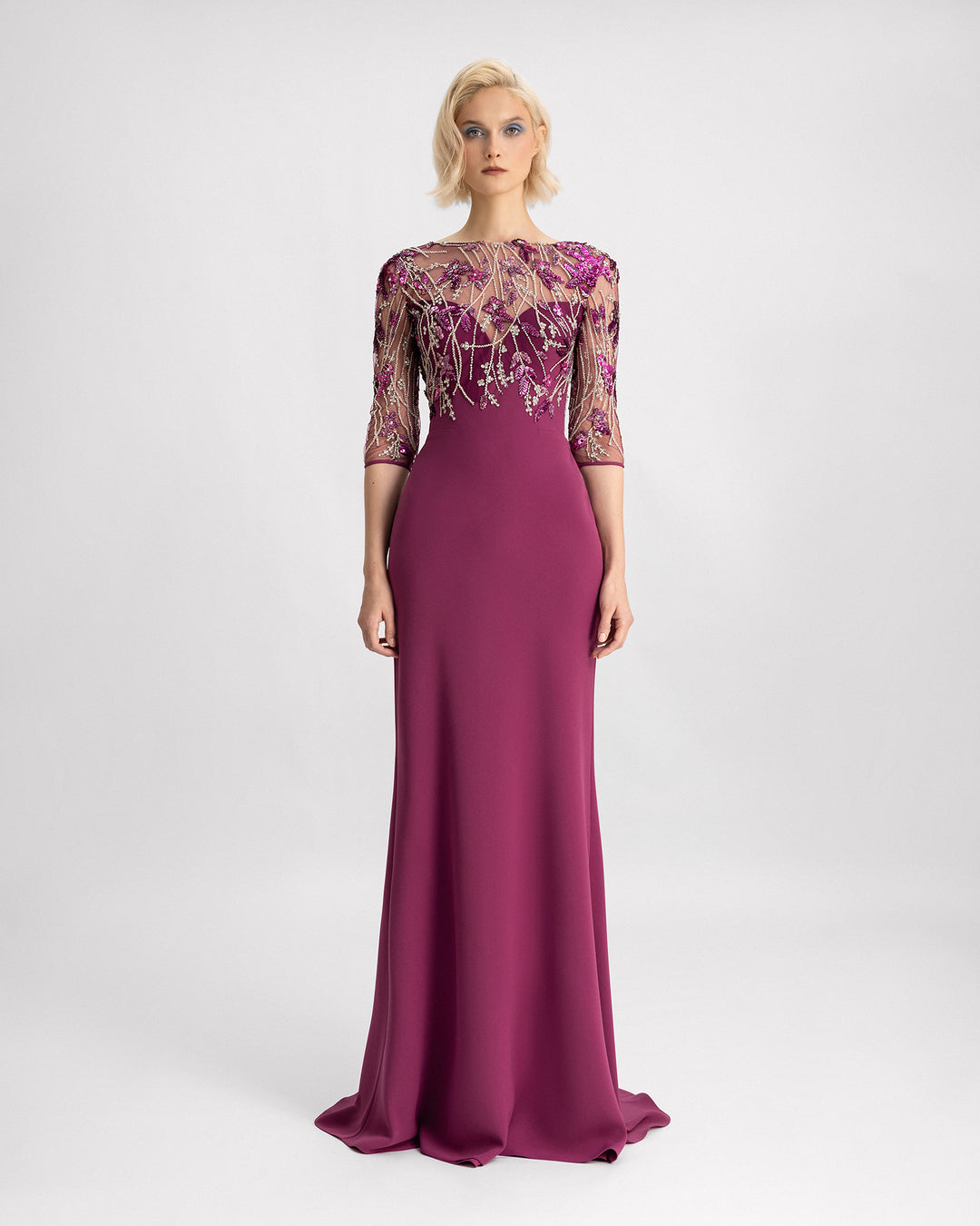 A slim-cut evening dress in mulberry color with a beaded corset and three-quarter sleeves.