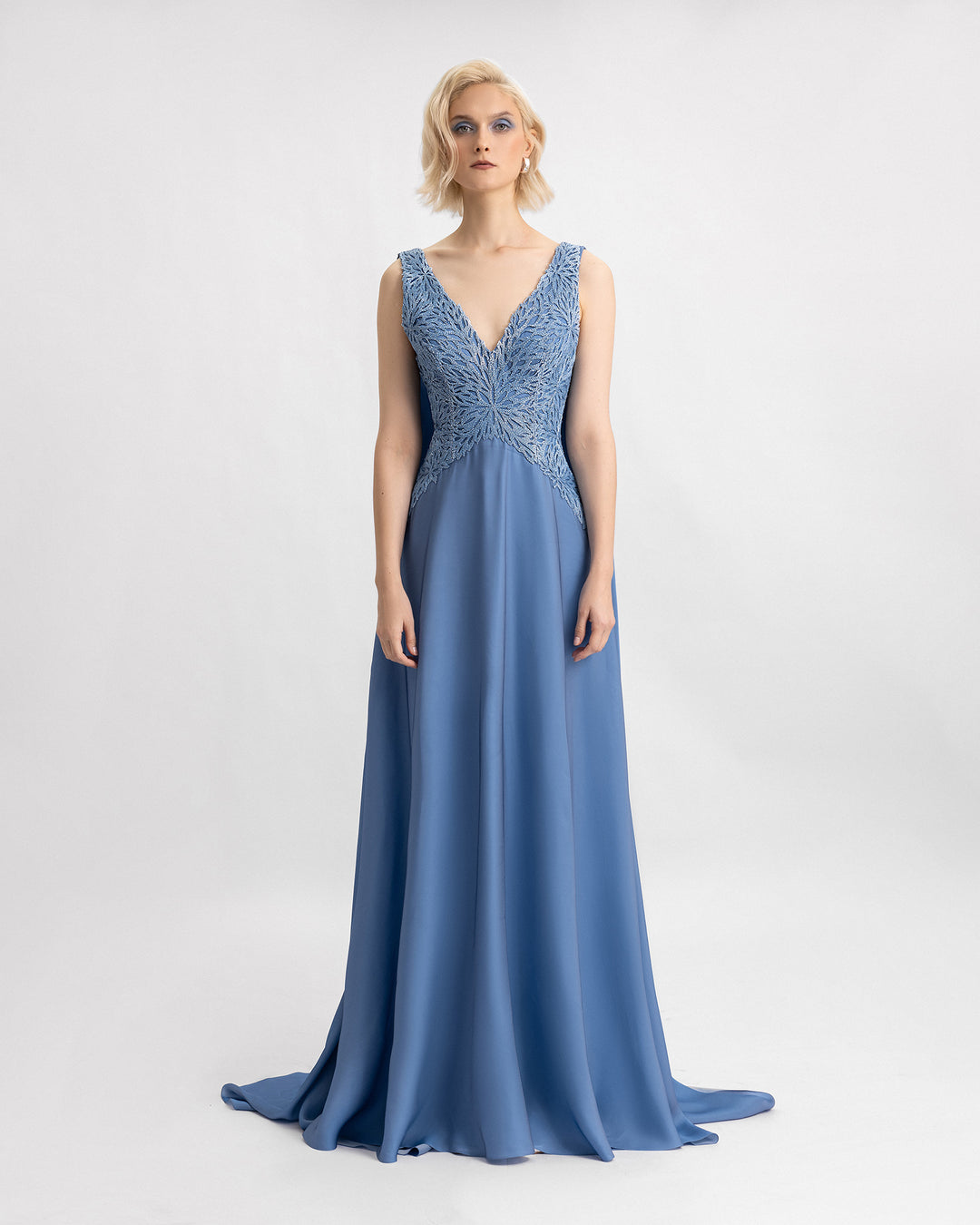 A V-neckline blue evening dress with a beaded corset and a flowy silk chiffon skirt.