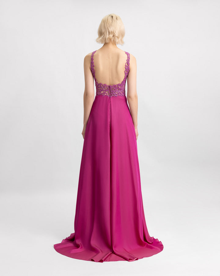 A open back evening dress in mulberry chiffon silk with a beaded bodice.