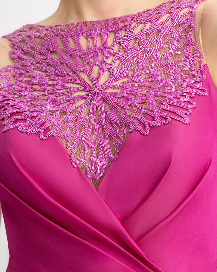 A close-up of a beaded neckline evening dress in mulberry chiffon silk.