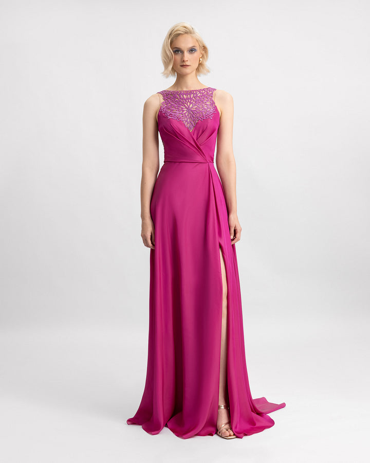 A boat-neckline evening dress in mulberry chiffon silk with a beaded neckline, draping on the waistline and a slit on the side.