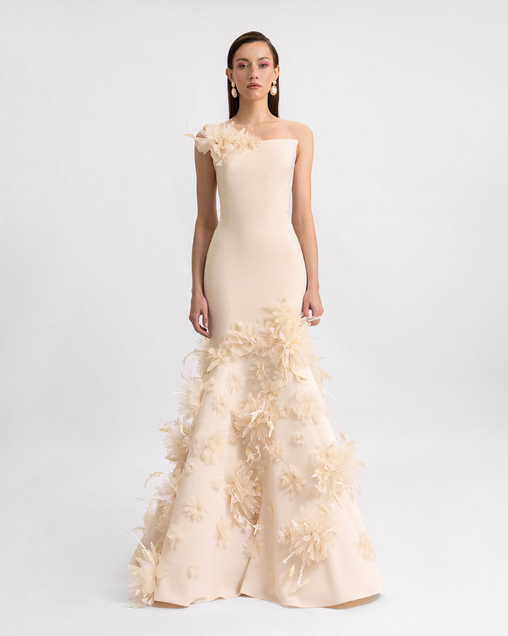 A mermaid-cut strapless evening dress in champagne color with 3D flower details.