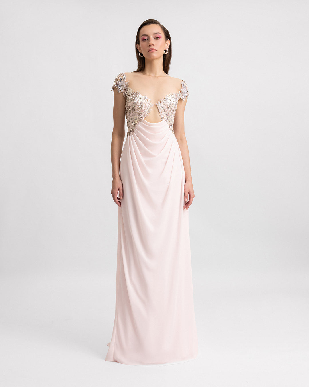 A long pink evening dress with a cut-out beaded corset and a draped crepe georgette skirt.