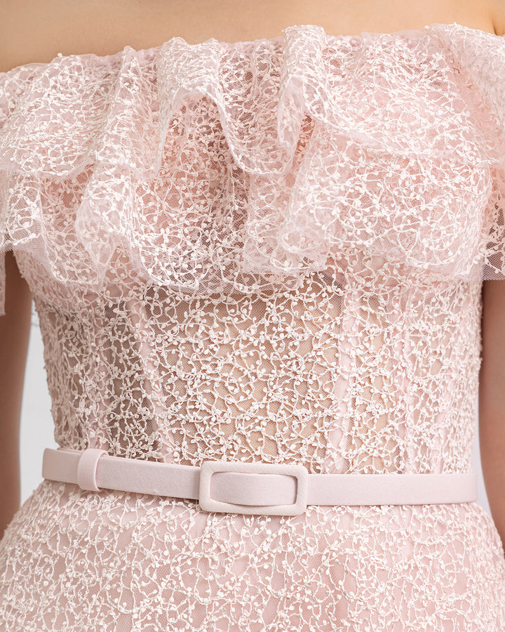 A close-up of an off-the-shoulders pink midi dress featuring ruffles on the neckline and a detachable belt. 