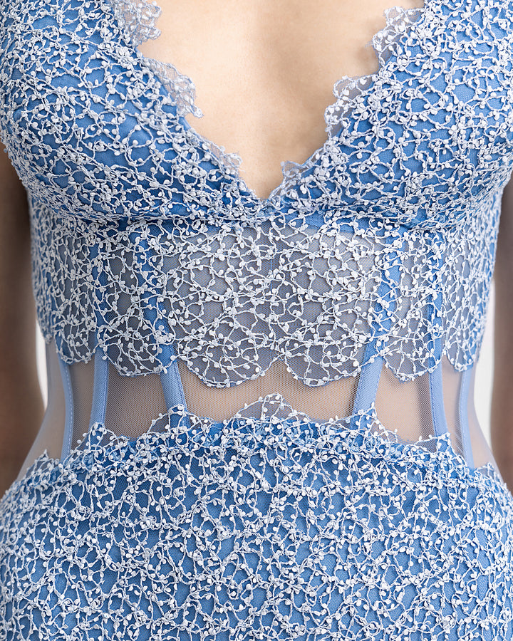 A close-up of a v-neckline midi dress featuring a see-through corset.