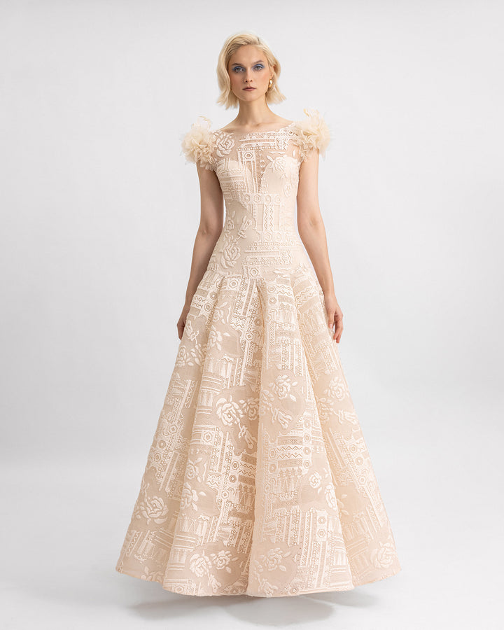 A lace beige evening dress with a dropped waistline and 3D flowers on the shoulders.