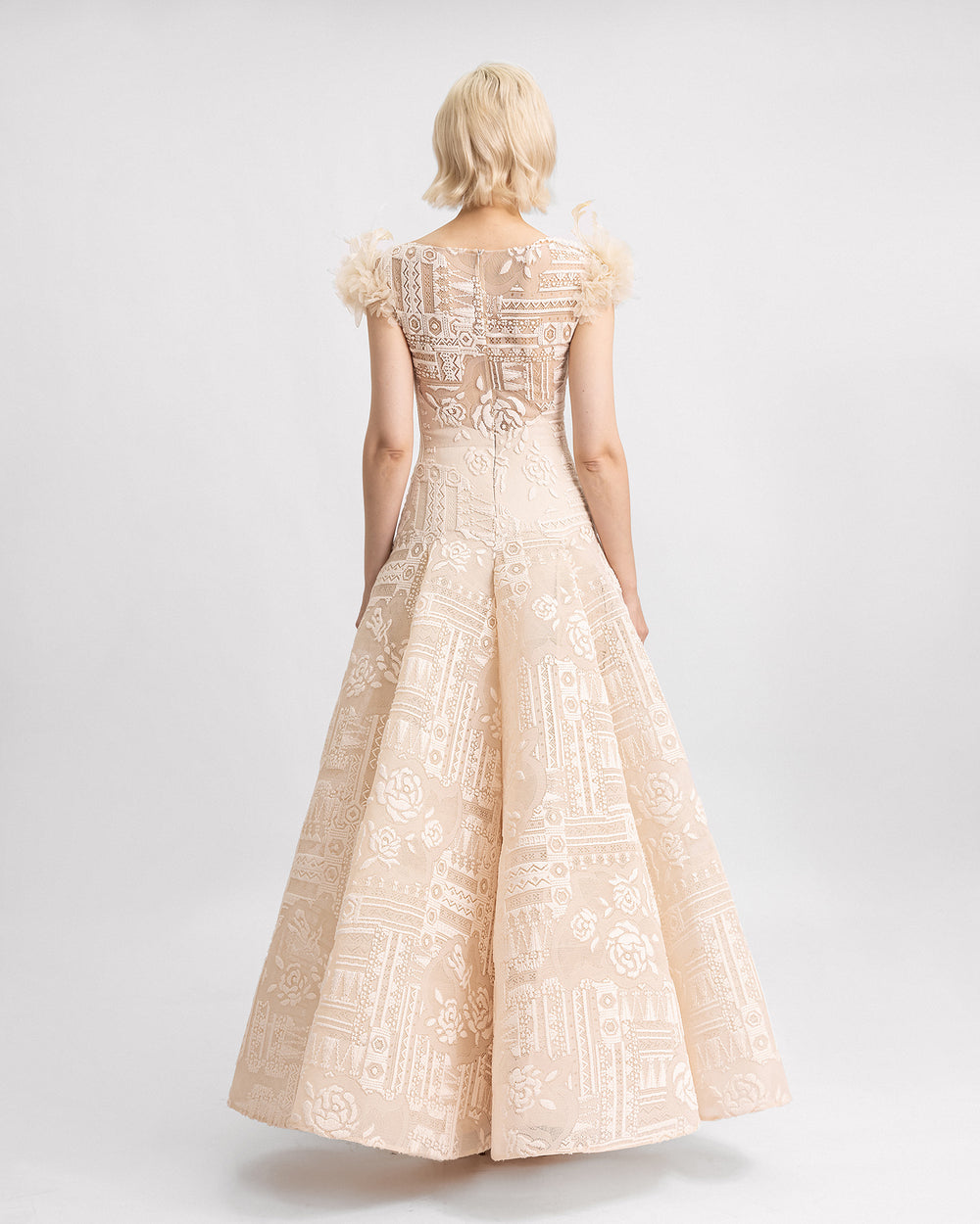 The back of Lace dress with a dropped waistline and 3D flowers on the shoulders.