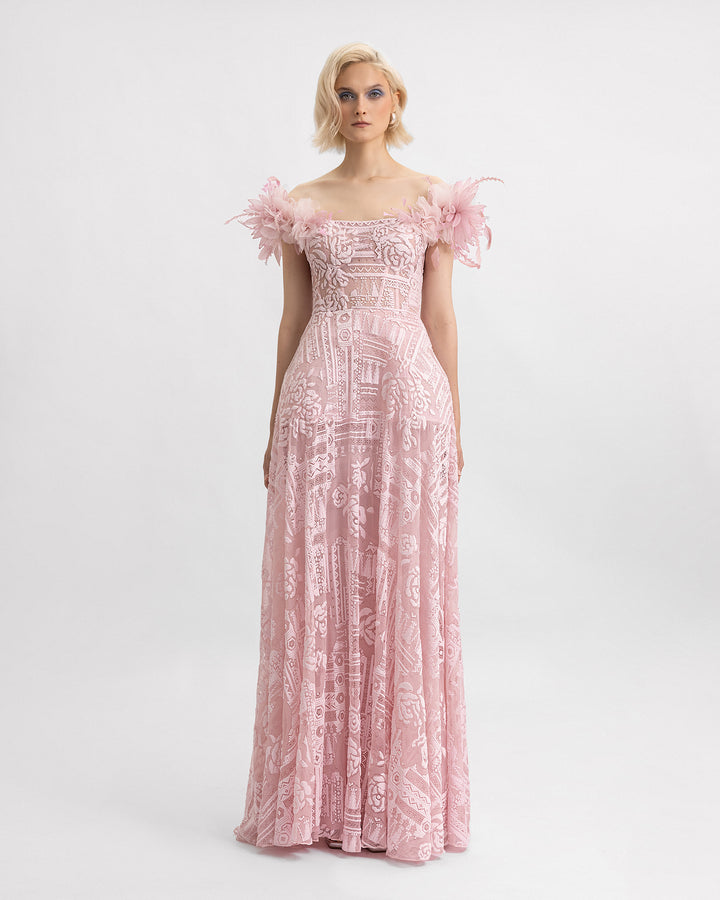 An off-the-shoulders pink lace evening dress with 3D flowers on the shoulders and a structured underskirt.