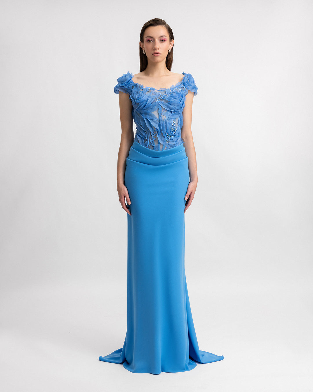 A slim-cut blue evening dress featuring a floral embroidered corset and a draped skirt.