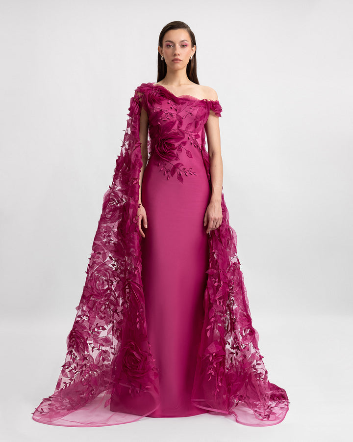 An asymmetrical neckline evening dress in mulberry color with an embroidered floral organza cape.