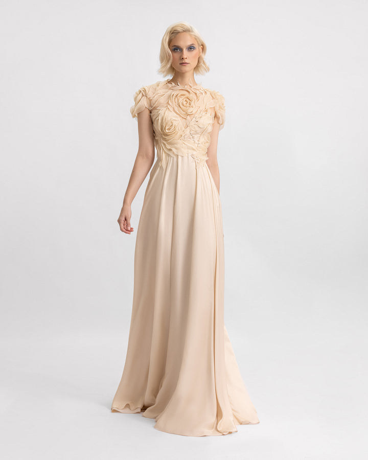 A long champagne evening dress with a floral embroidered corset and a silk chiffon flowy skirt.