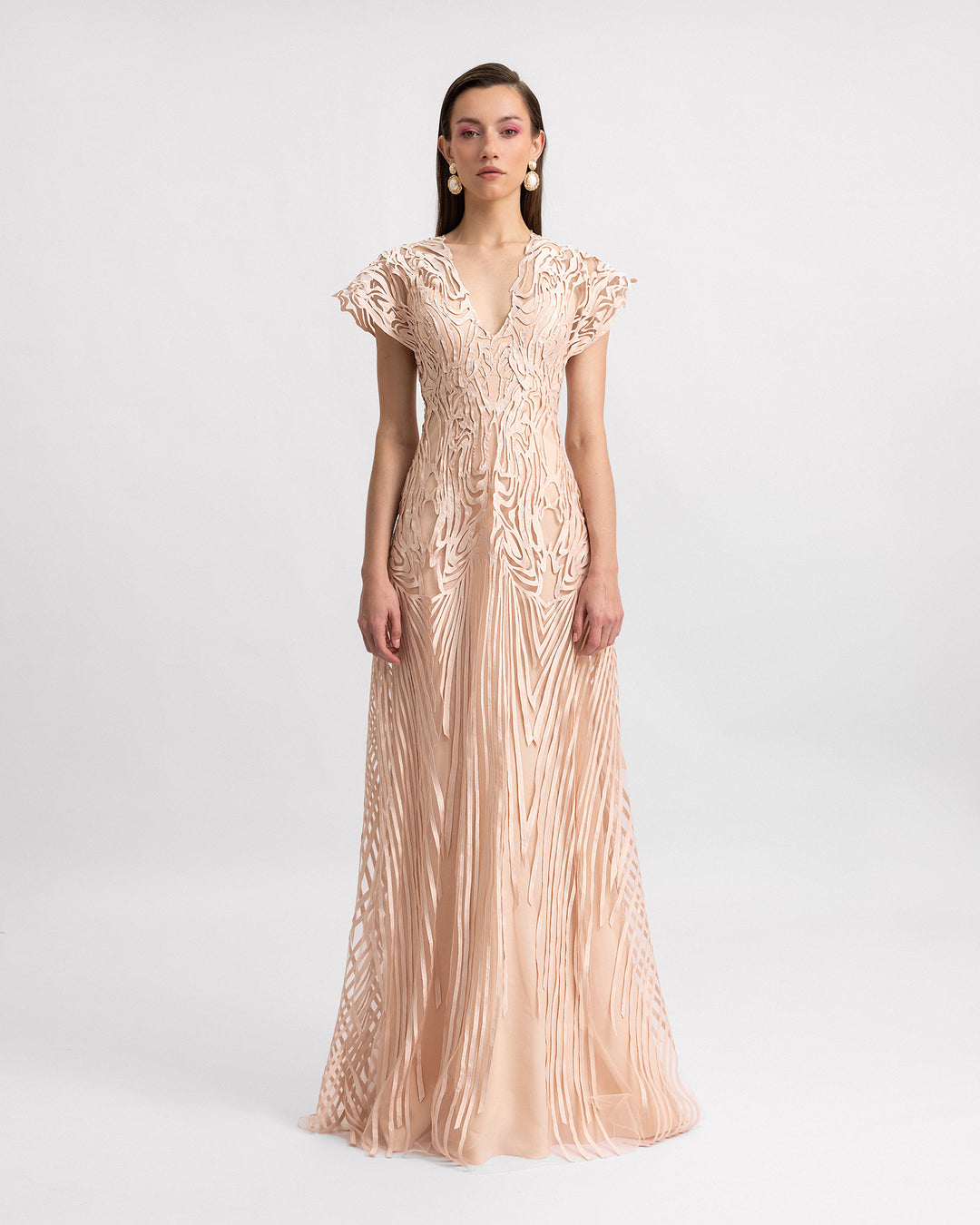 A v-neckline evening dress in embroidered laser-cut fabric featuring structured short sleeves.