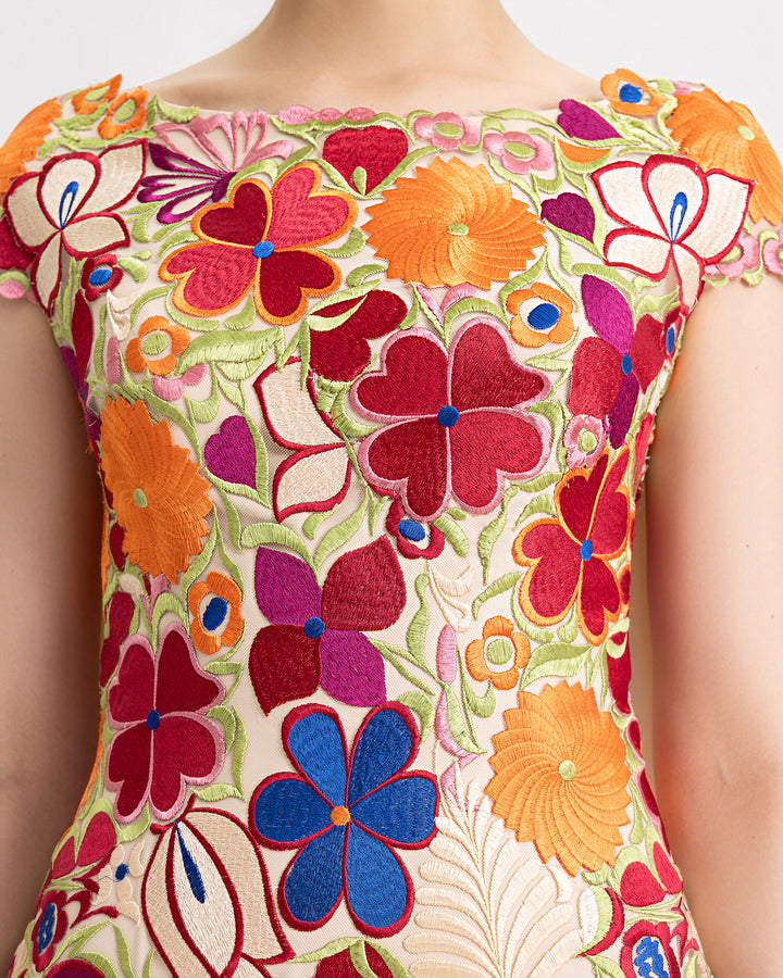 a close-up of a slim-cut evening dress in multicolor floral guipure fabric.