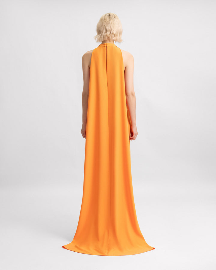 The back of an orange crepe cape evening dress.