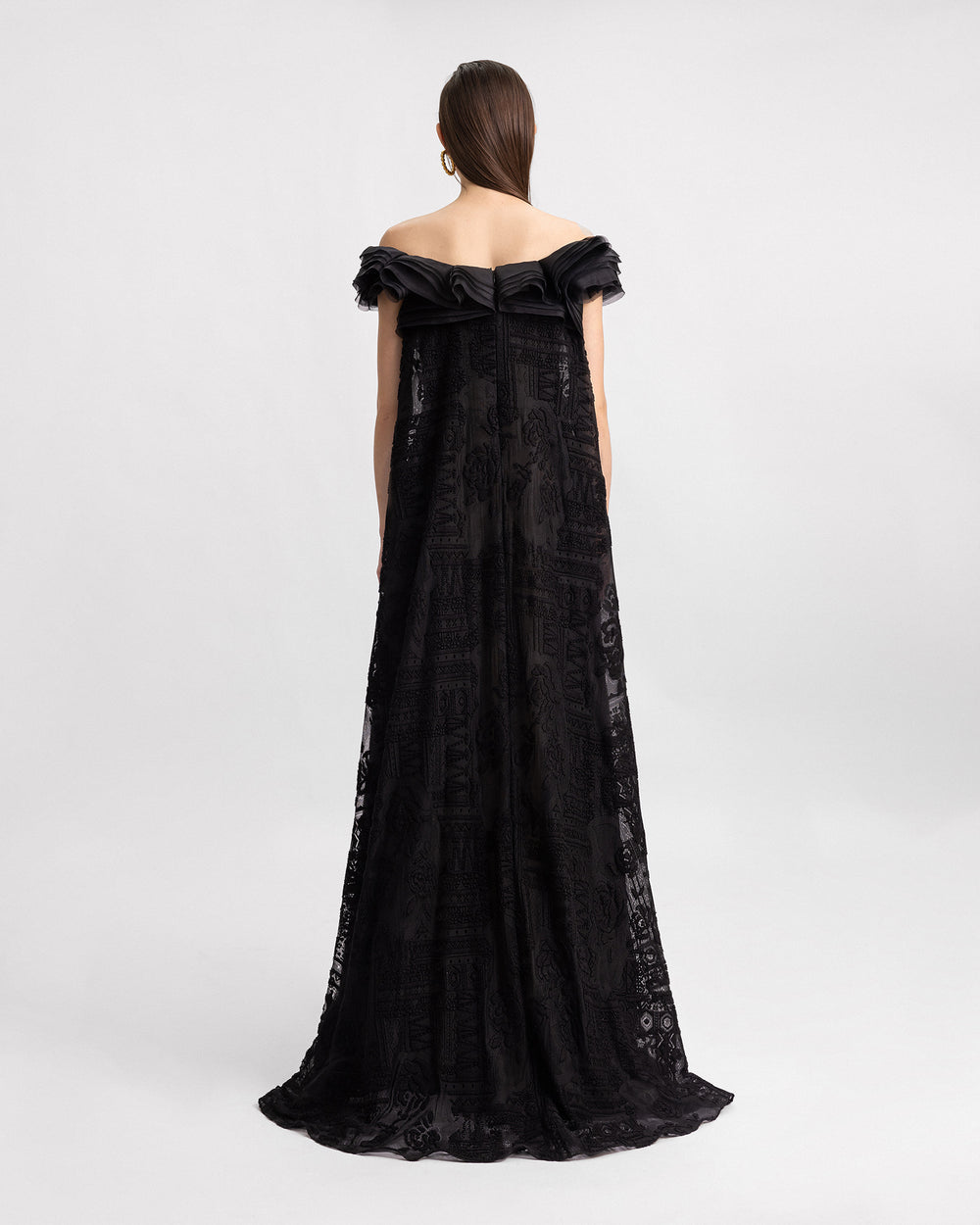 An off-the-shoulders loose-cut black lace evening dress with organza details on the neckline.