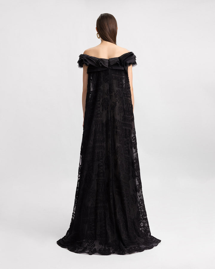 An off-the-shoulders loose-cut black lace evening dress with organza details on the neckline.