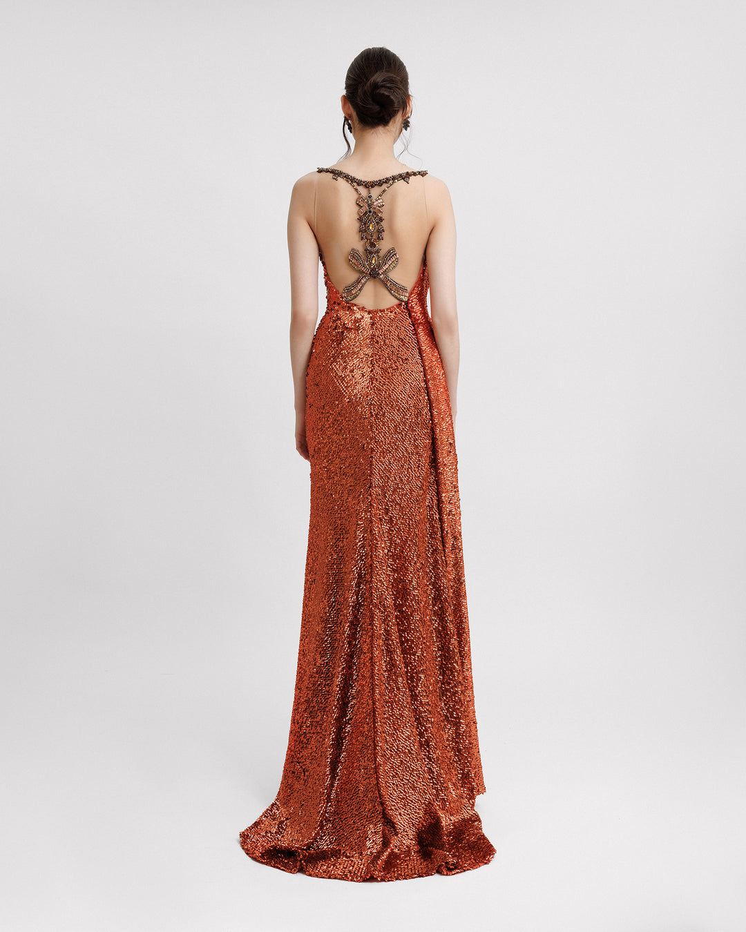 The back of a long fully sequined evening dress with a beaded open back.