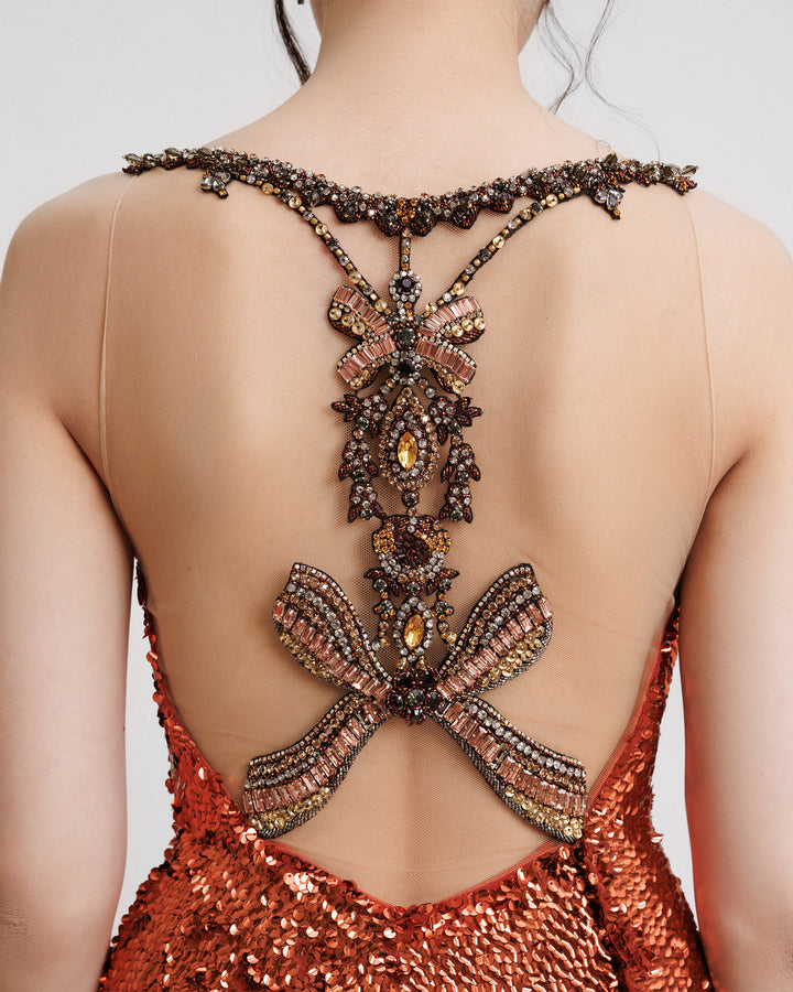 The back of a fully sequined evening dress with a beaded open back.