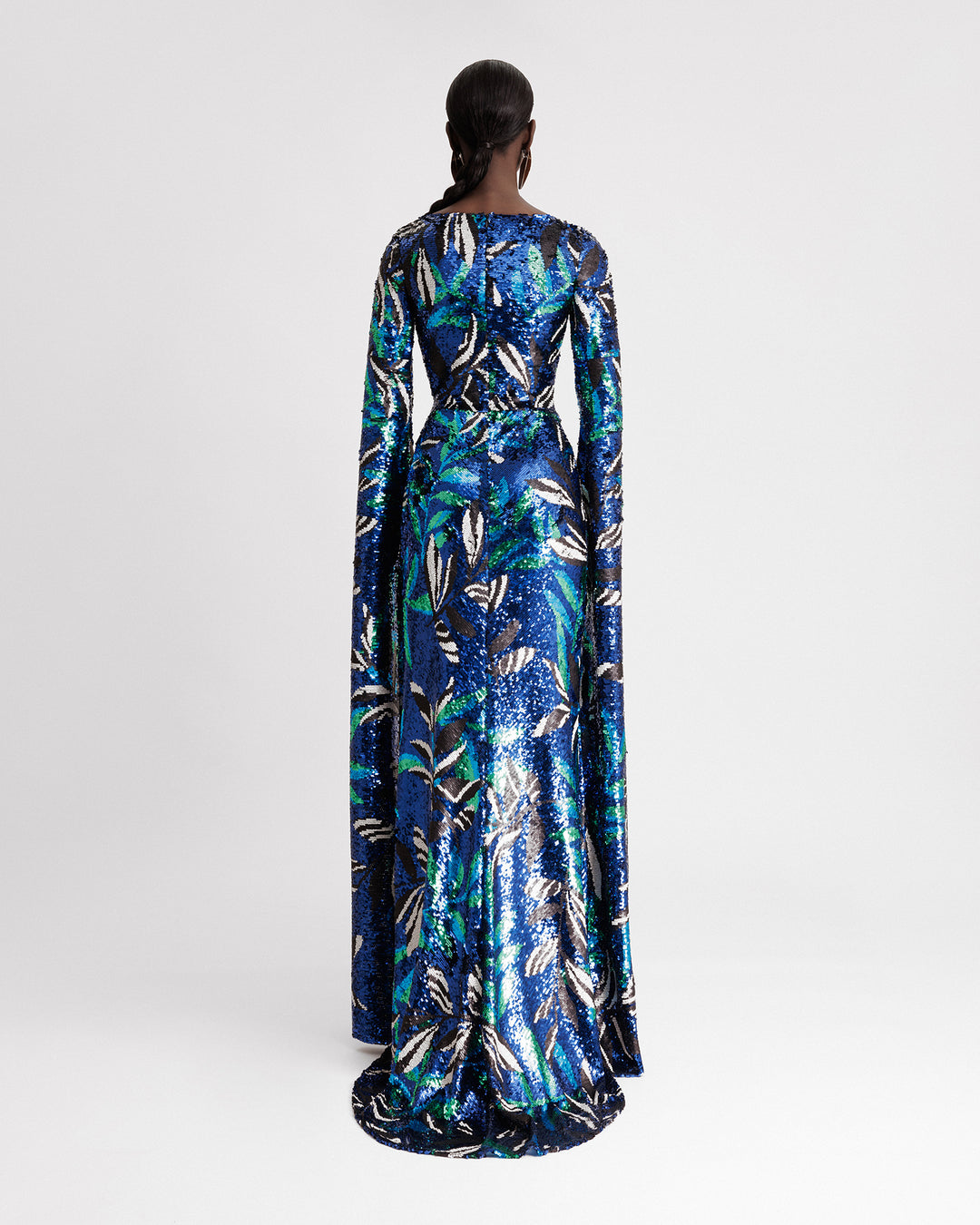 The back of a slim-cut evening dress featuring floor-length sleeves in a blue patterned sequins fabric.