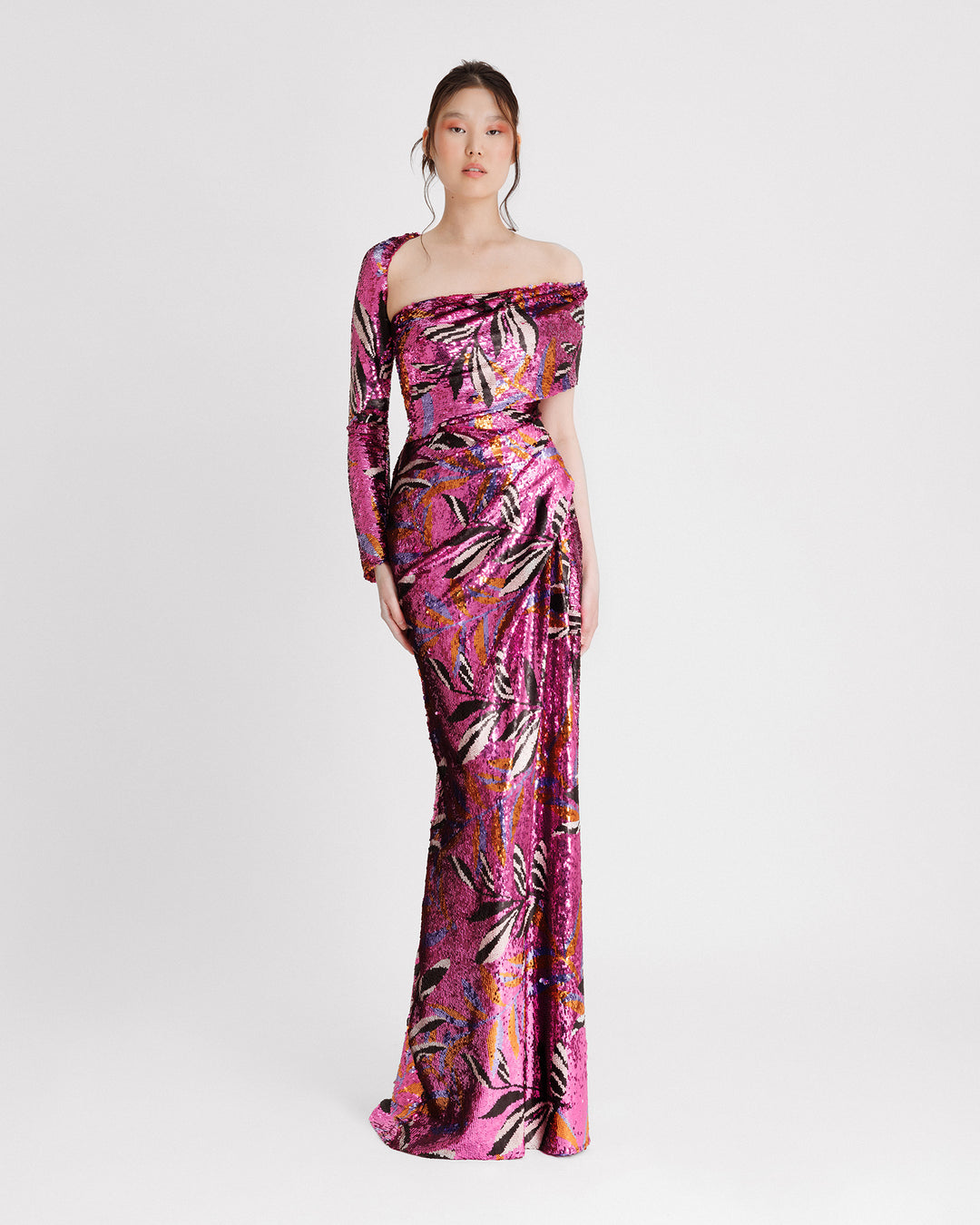 A one sleeved asymmetrical neckline, slim-cut evening dress with draping on the waistline in a patterned sequins fabric.