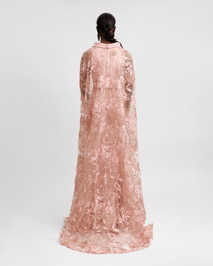 The back of a slim-cut evening dress with a fold-over collar, and cape-like sleeves in floral embroidered tulle.