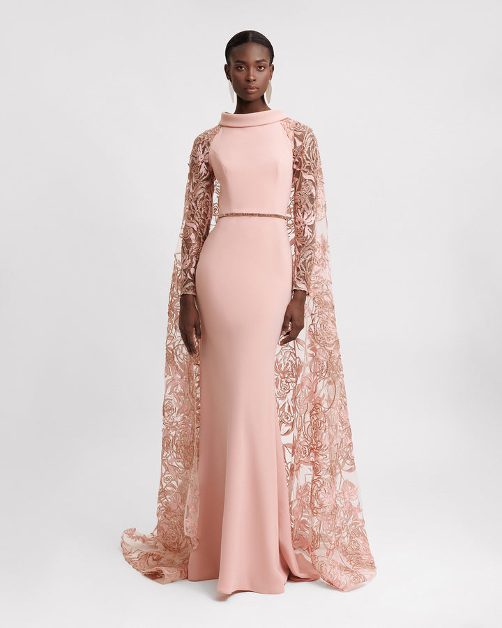 A Slim-cut plain evening dress with a fold-over collar, beaded waistline, and cape-like sleeves in floral embroidered tulle.