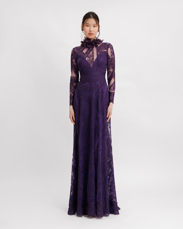 A long sleeved evening dress in purple patterned lace fabric, featuring a see-through plunging neckline and embroidered floral feathers on the collar.